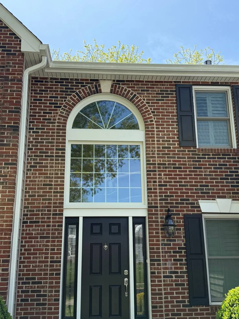 Large arched window and entry door