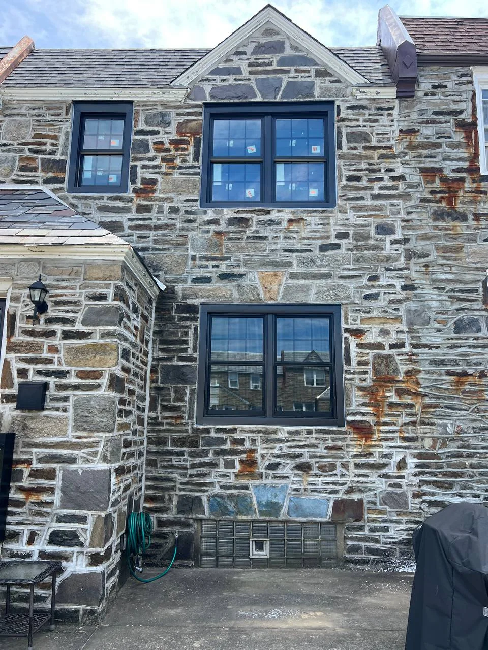 Black windows in stone home