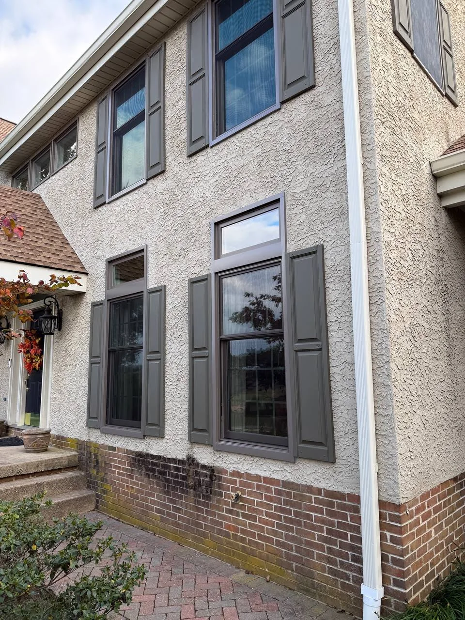 Black replacement windows on stucco home